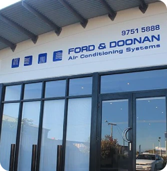 Storefront sign reading 'FORD & DOONAN Air Conditioning Systems' above glass doors, with phone number 9751 5888.